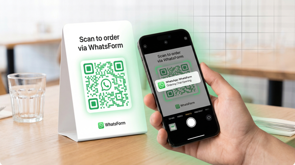 WhatsApp QR code on a restaurant table tent card being scanned with a phone